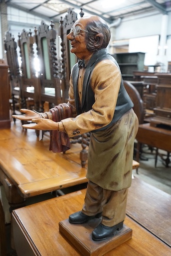 A painted composition dumb waiter in the form of an elderly butler, width 34cm, height 95cm